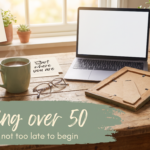 Kitchen table with reading glasses, a laptop and a card reading Experience counts, under the words Starting over 50